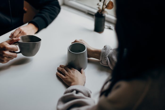 Two people sharing a warm conversation over coffee
